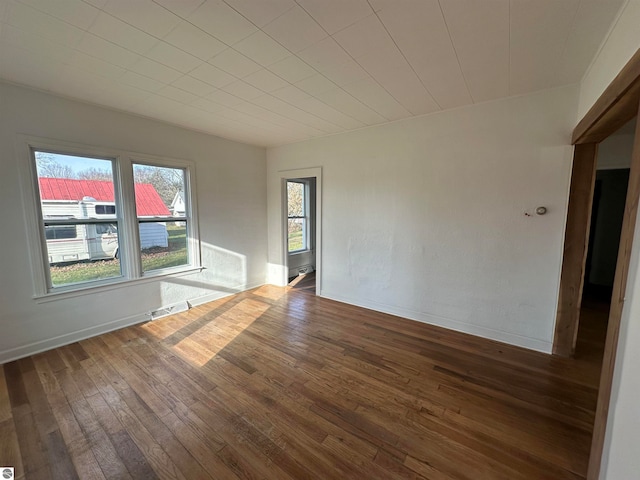 spare room with dark hardwood / wood-style flooring