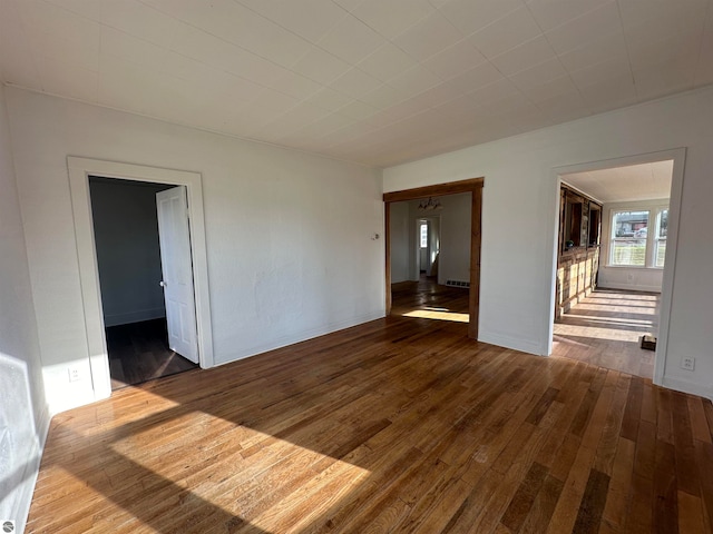 empty room with hardwood / wood-style floors