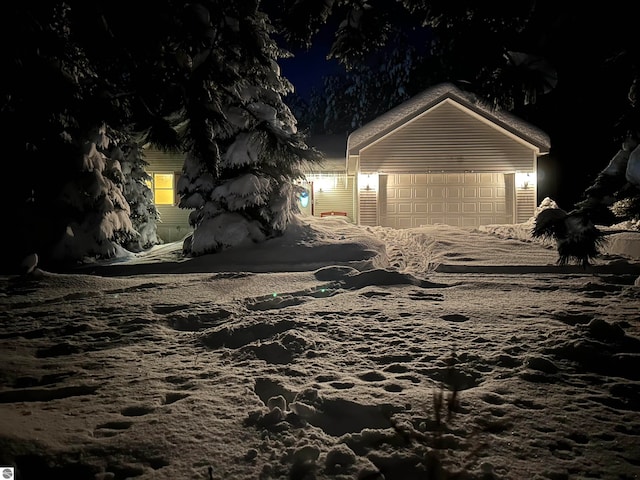 view of front of house with a garage and an outdoor structure