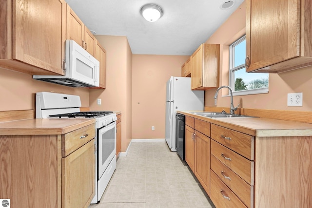 kitchen featuring white appliances and sink