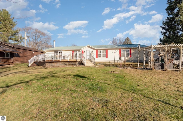 rear view of property with a yard and a wooden deck