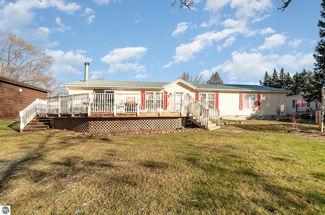 back of house featuring a yard and a deck