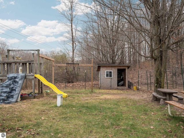 view of yard featuring a playground and a shed