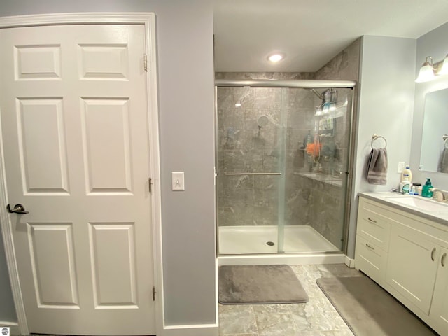 bathroom with tile patterned flooring, vanity, and a shower with door