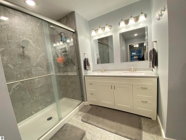 bathroom featuring tile patterned flooring, vanity, and a shower with shower door