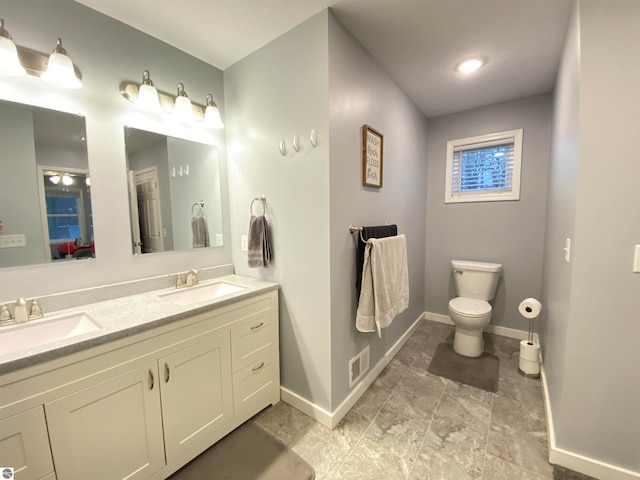 bathroom featuring vanity and toilet