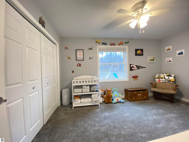 unfurnished bedroom with ceiling fan, a closet, and dark colored carpet