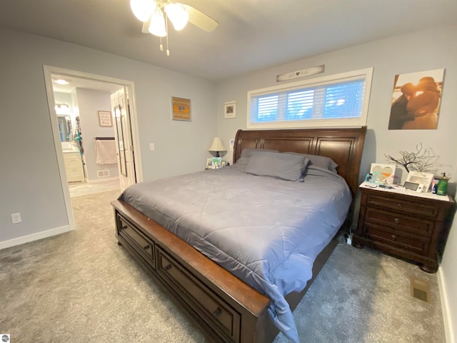 carpeted bedroom featuring ensuite bath and ceiling fan