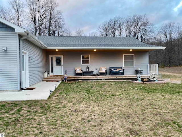 exterior space with outdoor lounge area, a yard, and a wooden deck