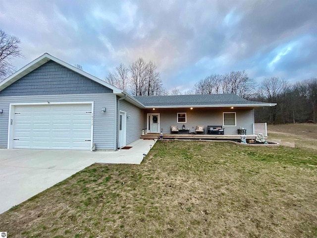 single story home with a garage and a front lawn