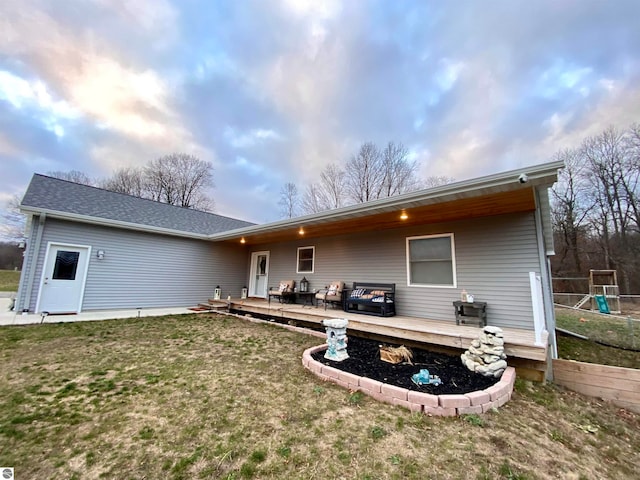 back of house with a yard and a deck