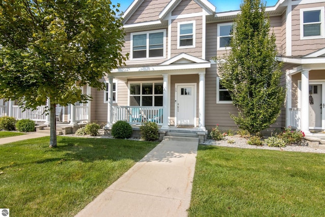 view of front of house featuring covered porch and a front yard