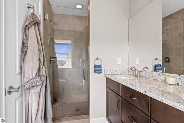 bathroom featuring vanity and a shower with door