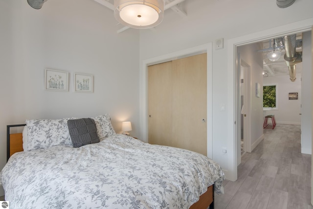 bedroom with ceiling fan and light wood-type flooring