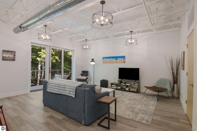 living room with wood-type flooring and a towering ceiling