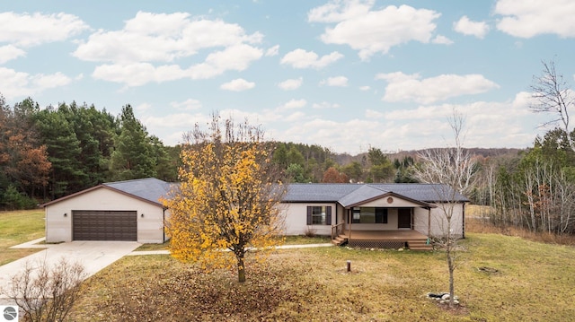 single story home featuring a front yard, a garage, and covered porch