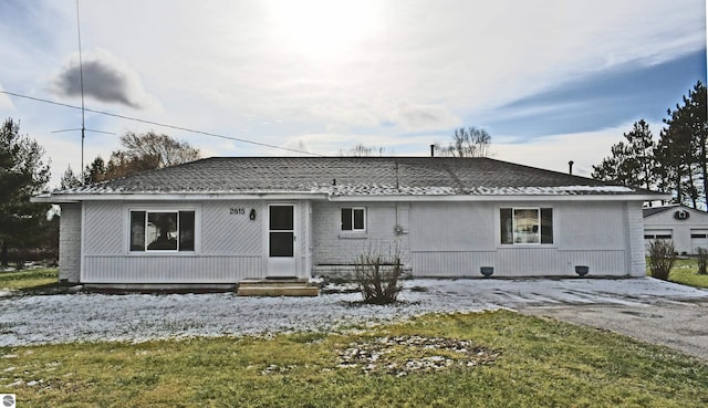 rear view of house featuring a lawn