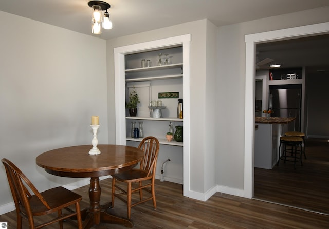 dining room with dark hardwood / wood-style flooring