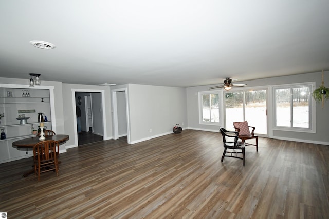 sitting room with ceiling fan and dark hardwood / wood-style flooring