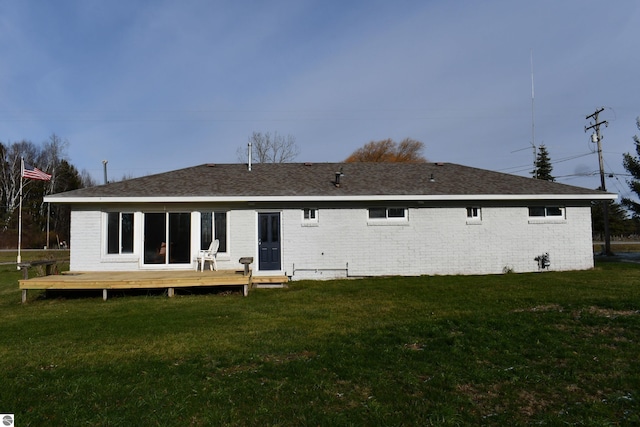 rear view of house featuring a yard and a deck