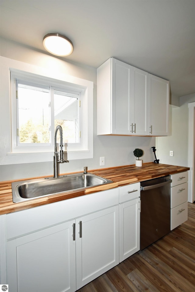 kitchen with white cabinetry, stainless steel dishwasher, dark wood-type flooring, and sink