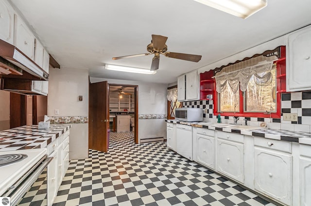 kitchen with decorative backsplash, a baseboard radiator, white cabinetry, and sink