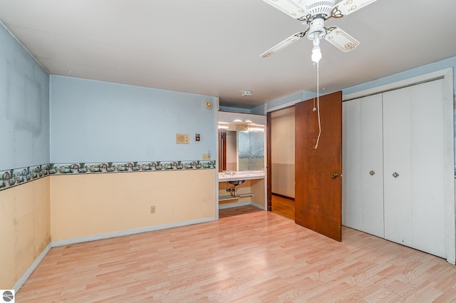 unfurnished bedroom with ceiling fan and light hardwood / wood-style floors