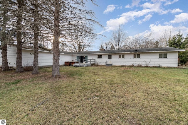 rear view of property with a yard