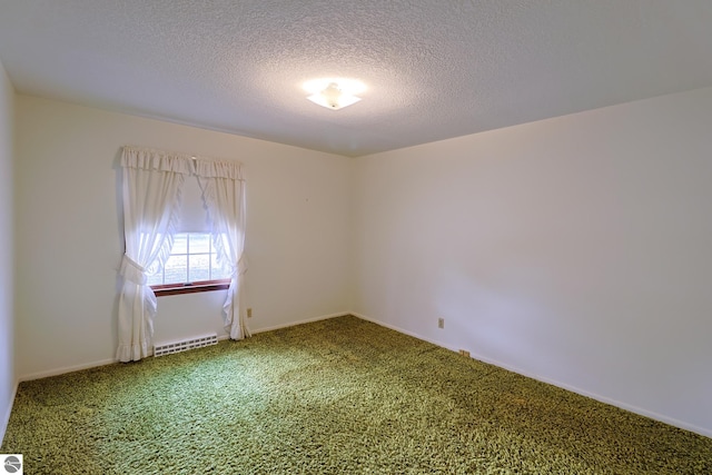 carpeted spare room with a textured ceiling