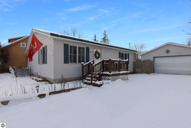 view of front of house featuring a garage and an outdoor structure