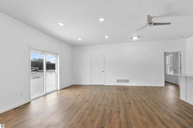 spare room with ceiling fan and dark wood-type flooring