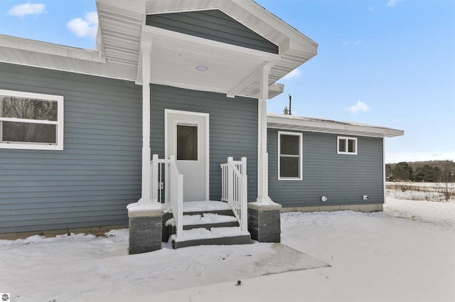 view of snow covered property entrance