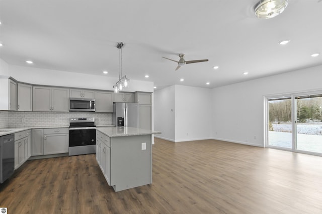 kitchen with gray cabinetry, ceiling fan, stainless steel appliances, and dark wood-type flooring