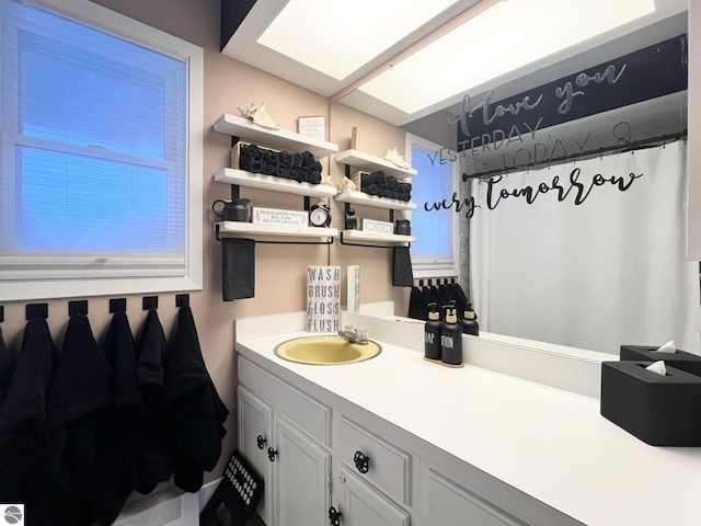 bathroom with a shower with shower curtain and vanity