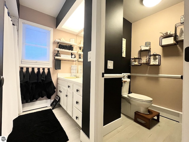 bathroom featuring tile patterned floors, vanity, and toilet