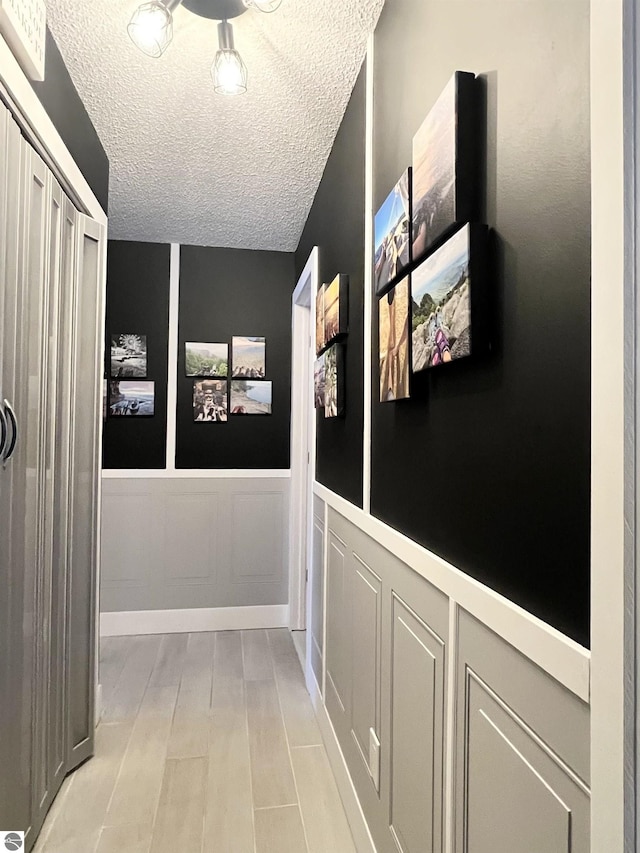 corridor featuring a textured ceiling