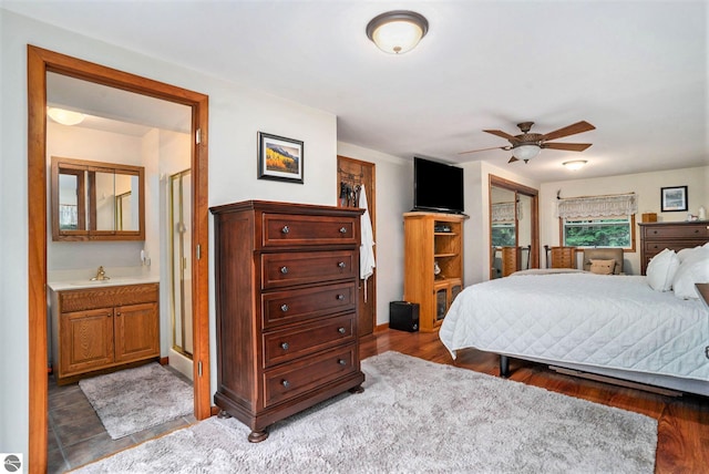 bedroom with sink, ceiling fan, dark hardwood / wood-style flooring, and ensuite bathroom