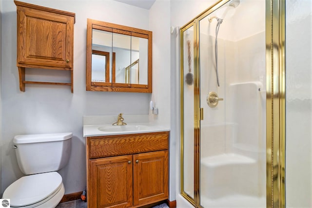 bathroom with a shower with door, vanity, and toilet