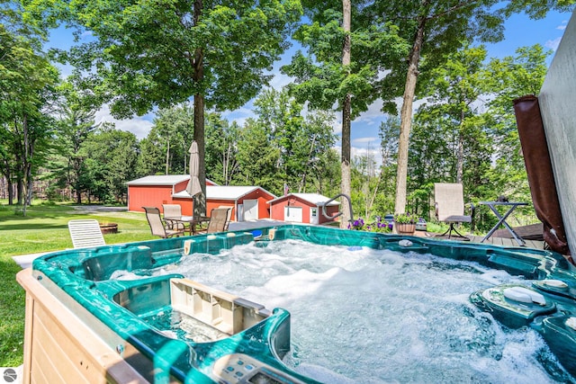 view of pool with a yard and a hot tub