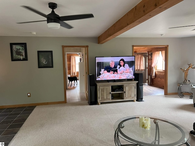 tiled living room featuring ceiling fan and beamed ceiling