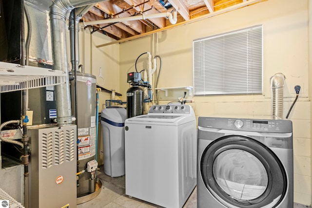 laundry room with gas water heater, independent washer and dryer, and heating unit