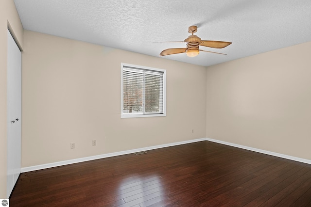 spare room with ceiling fan, wood-type flooring, and a textured ceiling