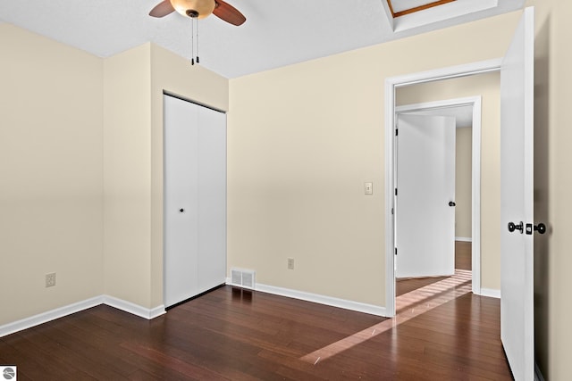 unfurnished bedroom featuring ceiling fan, a closet, and dark hardwood / wood-style floors