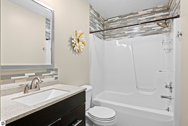 full bathroom with backsplash, a textured ceiling,  shower combination, toilet, and vanity