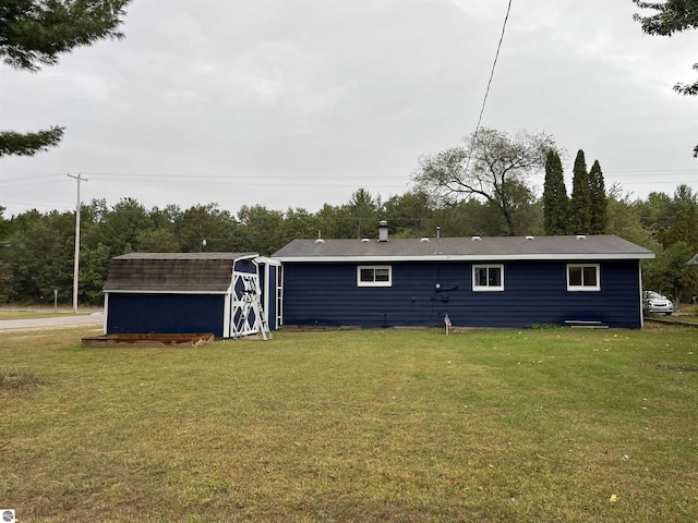 back of property with a storage shed and a yard