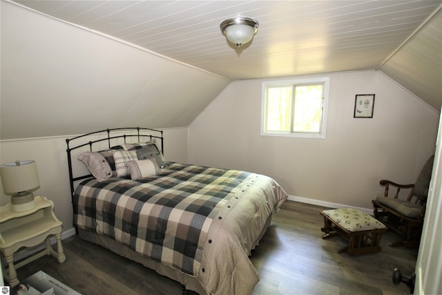 bedroom featuring hardwood / wood-style floors and lofted ceiling