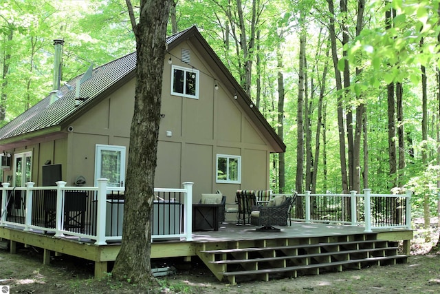 back of house featuring a wooden deck