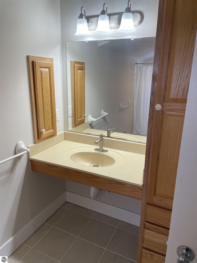309 E Wisconsin, Mount Pleasant, MI 48858 - bathroom featuring tile patterned floors, curtained shower, baseboards, and vanity