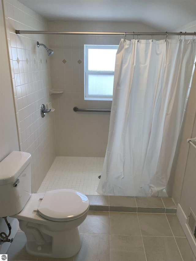 full bathroom featuring tile patterned flooring, visible vents, a shower stall, and toilet