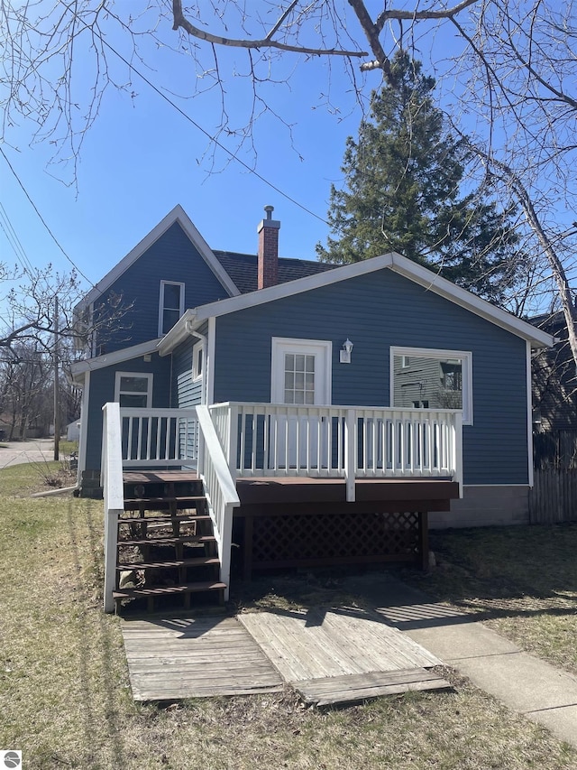 309 E Wisconsin, Mount Pleasant, MI 48858 - rear view of property featuring a chimney, a wooden deck, and stairway